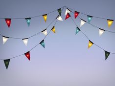 multi colored flags are hanging in the sky