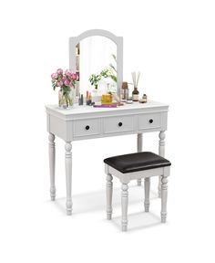 a white vanity table with a mirror and stool next to it on a white background