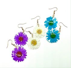 Handmade earrings made with love and care! They are an excellent addition to any wardrobe for a simple yet elegant look. 🌸 One pair of resin earrings with a delicate pressed daisy 🌸 Materials: Pressed daisy flower & Resin Your jewelry is handcrafted, making each perfectly unique and beautiful just like you!   For each purchase, $2 will go towards funding my organization: MAUA Women's Foundation that aims to provide sustainable feminine hygiene products to girls in rural Kenya, Africa. Facebook page: https://www.facebook.co/MAUAWomensFoundation Care: Remove your jewelry when in contact with water or liquids such as perfume or lotion. Store your beautiful resin jewelry in a cool dark place and out of direct sunlight to maintain the vibrant colors. Resin Flower Charm Earrings, Real Flower Earrings, Feminine Hygiene Products, Pressed Flower Earrings, Flower Resin, Hygiene Products, Feminine Hygiene, Daisy Earrings, Earrings Christmas