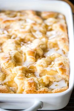 a casserole dish with bananas and cream in it on a cooling rack, ready to be eaten