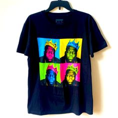 a t - shirt with the image of two men wearing crowns on it, hanging from a hanger