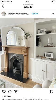 a living room filled with furniture and a fire place in front of a white bookcase