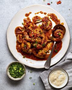 a white plate topped with shrimp covered in sauce