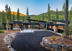 a modern home in the mountains surrounded by trees