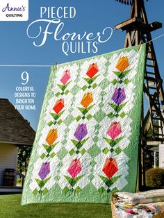 the cover of quilting magazine, featuring an image of a windmill with flowers on it