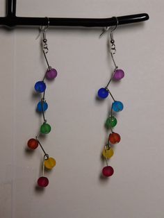 Cute and fun multicolored dangle earrings Frosted multicolored beads staggered on silver wire. Multicolor Czech Glass Beaded Earrings For Party, Multicolor Glass Drop Earrings, Rainbow Dangling Beads Earrings For Party, Multicolor Dangle Linear Earrings, Multicolor Wire Wrapped Dangle Beaded Earrings, Multicolor Czech Glass Beaded Earrings For Pierced Ears, Multicolor Wire Wrapped Drop Earrings, Multicolor Glass Earrings With Colorful Beads, Multicolor Glass Beaded Earrings