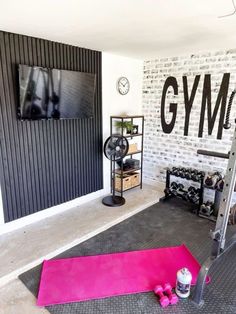 there is a gym room with a pink mat on the floor