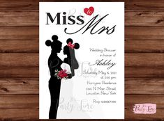 a wedding card with the silhouette of a bride and groom kissing in front of a wooden background