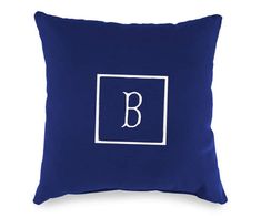 a blue pillow with the letter b on it and a white square in the middle