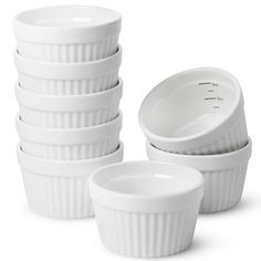 a stack of white dishes sitting next to each other