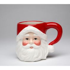 a red and white santa claus mug on a gray background with the face of an adult