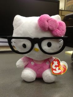 a hello kitty stuffed animal wearing glasses