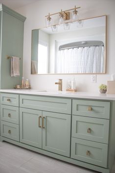 Green bathroom cabinets and gold hardware/accents Mint Vanity Bathroom, Green Bathroom Vanity Brass Hardware, Mint And Gold Bathroom, Beige Painted Cabinets Bathroom, Guest Bathroom Sage Green, Mint Green Bathroom Cabinets, Sea Foam Green Bathroom Vanity, Seafoam Green Cabinets, Mint Bathroom Vanity