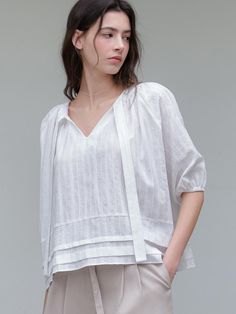 This is a minimal and feminine top by ourcomos that is made out of high quality and sturdy material. With distinctive mood of the design and comfortable wear, you can use it for your daily lifestyle.- V Neckline and long tie- Banding on the sleeve for balloon shape- Modern and minimal mood Elegant Everyday Linen Tops, Elegant Summer Top For Everyday, Modern Summer Tops For Casual Gatherings, Versatile Blouse For Casual Spring Gatherings, Versatile Spring Blouse For Casual Gatherings, Modern Linen Tops For Casual Wear, Modern Linen Tops For Casual Gatherings, Spring Casual Versatile Blouse, Effortless Summer Workwear Tops