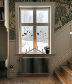 a room with a radiator, bookshelf and window