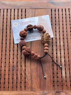 This is a divine bracelet made from natural auspicious beads of 2 - 7 mukhi Rudraksha in black adjustable chord.  This bracelet is adjustable so can fit any wrist size.  This is a healing Shiva bracelet, blessed by priest. The benefits of  2 Mukhi Rudraksha signifies the unity of SHIVA and SHAKTI    We wish you happy wearing and chanting Spiritual Brown Beaded Bracelets For Rituals, Spiritual Braided Bracelets With Round Beads For Meditation, Adjustable Traditional Bracelets For Rituals, Spiritual Brown Bracelet For Festivals, Spiritual Brown Bracelet For Meditation, Spiritual Brown Bracelets For Festivals, Spiritual Brown Bracelet For Rituals, Brown Spiritual Bracelets For Meditation, Traditional Hand Wrapped Brown Bracelet