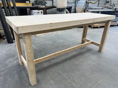 a wooden table being built in a shop