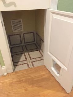 an open door leading to a bathroom with tiled flooring and walls in the background