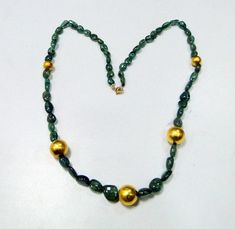 "vintage Designer 22 ct gold and high-quality natural Emerald gemstone beads necklace. Fully handcrafted vintage old 22 ct gold beads strung together with natural Oval shape emerald gemstones beads. Total Length-57 cm(22.44\")we can adjust the length, size of center gold bead-13 mm, Emerald size-12/9 mm, Emerald weight-125 carats, net gold weight approx-5 grams." Antique Gold Polished Beads, Antique Polished Gold Beads, Antique Large Gold Beads, Antique Gold Beaded Necklaces With Large Beads, Antique Gold Necklace With Large Beads, Gold Emerald Necklace With Rondelle Gemstone Beads, Gold Emerald Necklace With Round Beads And Spiritual Style, Gold Spiritual Emerald Necklace With Round Beads, Gold Emerald Necklace With Gemstone Beads