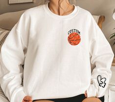 Personalized Basketball Sweatshirt,Your Name Basketball Sweater,Basketball Family Sweater,Custom Number On Sleeve,Custom Basketball Hoodie WELCOME TO "DandelionDesignUShop" ! High quality and super soft, comfortable shirt. Made with top of the line vinyl and pressed with a professional grade heat press. All our simple color ones like White, Black, and Red are 100% Cotton. All our Heathered Colors are cotton/polyester blend and they are super comfy soft!   SIZING AND COLORS Make sure you check ou White Varsity Sweatshirt For Baseball Season, White Team Spirit Sweatshirt For Baseball Season, White Hoodie With Team Logo For Streetwear, White Varsity Hoodie For Game Day, White Sports Fan Tops, White Team Logo Hoodie For Sports Season, White Hoodie With Team Logo For Sports Season, White Varsity Hoodie For College, Sporty Long Sleeve Basketball Top