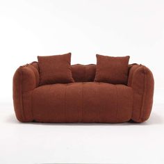 a brown couch sitting on top of a white floor