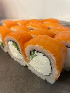 sushi rolls with cream cheese and salmon on them