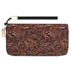 a brown leather wallet with flowers and leaves on it