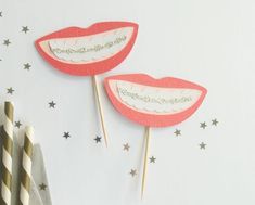 two tooth shaped lollipops sitting on top of each other in front of stars