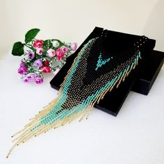 "Luxurious exclusive necklace for special occasions.Flowing tassel beads necklace.Bohemian dangle beaded necklace with fringe are made of high quality Czech and Japanese seed beads. long earrings.Bead weaving techniques. Colors: Blue turquoise ,Matte black and gold color ! Details ! Made with quality Japanese and Czech seed beads ! Professional threads for weaving with beads Tytan and Fireline. ! neck girth length 15 inches.Neck length can be extended with an extension chain. ! The necklace is adjustable and fits any size.  The length of the falling necklace is 9.5 inch, ! INSTRUCTIONS FOR USE. Please avoid getting alcohol-containing cosmetics (Perfume ,deodorant, lotions) on jewelry. Please take off your jewelry before showering, sauna and sea access. You can store your jewelry in the pro Turquoise Necklaces With Tassel And Round Beads, Turquoise Beaded Necklace With Tassels And Round Beads, Turquoise Necklace With Tassels And Round Beads, Turquoise Beaded Necklace With Tassels, Bohemian Fringe Tassel Necklace For Parties, Bohemian Long Tassel Necklace For Party, Turquoise Beaded Necklace With Dangling Beads For Party, Bohemian Black Beads For Party, Bohemian Bib Necklaces With Dangling Beads For Party