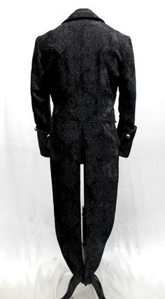 A luxurious, stylish formal coat with tails suitable for a maestro or a virtuoso. A tailcoat made in gorgeous black velvet with an intricate fleur de lis design on it. Fully lined with sleek black satin lining inside. A formal collar, long pointed tails and wide cuffs with medieval lion metal buttons at front and on cuffs give this coat a vintage style. Two small pockets on either side in front. Perfect for the most grand performance or masquerade..this coat is amazing! Comes in sizes: Small-3X. Black Fitted Tuxedo Outerwear, Fitted Black Tuxedo Outerwear, Elegant Fitted Suits With Stand Collar, Fitted Long Sleeve Noble Outerwear, Noble Fitted Winter Outerwear, Fitted Suit For Fall Costume Party, Fitted Suit For Costume Party In Fall, Gothic Black Outerwear For Formal Occasions, Black Gothic Outerwear For Formal Occasions