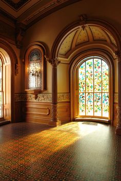 an empty room with stained glass windows and tiled floor