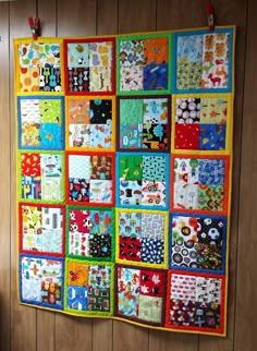 a colorful quilt hanging on the wall