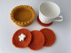 three crocheted coasters and a coffee cup