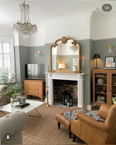 a living room filled with furniture and a large mirror on the wall above a fireplace