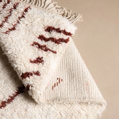 a white and red rug on the floor