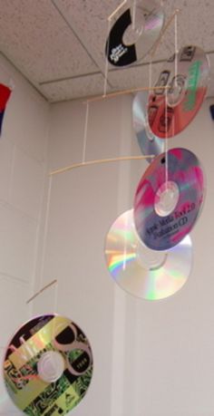 several cds are hanging from the ceiling in a room