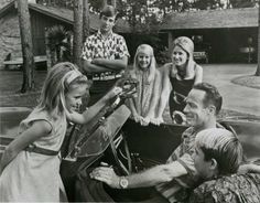 a group of people sitting in the back of a car with a child on it