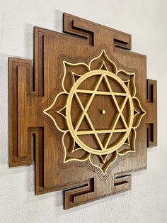 a wooden wall hanging with an intricate design