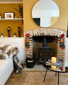 a living room filled with furniture and a fire place in front of a brick fireplace