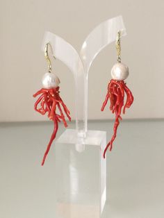 Elegant earrings with natural white bead and natural red coral from the Mediterranean coral sprig. Frame in worked golden brass. Measures length 8 cm Elegant White Red Coral Jewelry, Red Coral Earrings As Gift, Elegant Coral Colored Red Coral Earrings, Handmade Coral Earrings In Red Coral, Red Coral Earrings, Coral Earrings, The Mediterranean, White Beads, Red Coral