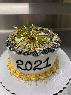 a white and yellow decorated cake sitting on top of a plate