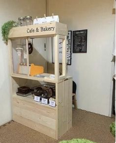 a small display case in the corner of a room with green carpet on the floor