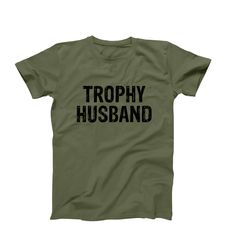 Trophy Husband T-Shirt, Funny Husband Shirt, Men's Funny Shirt, Trophy Spouse Shirt, Best Husband Anniversary Birthday Gift Idea ➤FEATURES: This listing includes one Unisex T-Shirt.  *  Available sizes S, M, L, XL, 2XL *  100%  Cotton *  Short Sleeve *  Crew Neck  ➤SIZING: Please keep in mind that our size chart measurements are NOT circumference.  UNISEX CREW NECK T-SHIRT SIZE CHART:  * S - 18" Width X 28" Length * M - 20" Width X 29" Length * L - 22" Width X 30" Length * XL - 24" Width X 31" L Anniversary T-shirt With Funny Text, Crew Neck, Funny Text Crew Neck T-shirt For Anniversary, Trophy Husband, Funny Husband, Husband Anniversary, Husband Shirts, Husband Humor, Best Husband, Funny Shirt