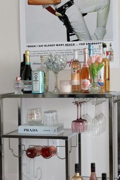 a bar cart filled with bottles and glasses