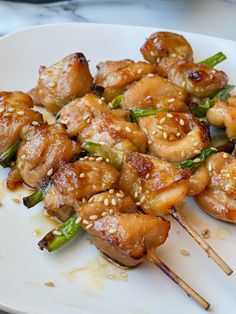 chicken and asparagus on skewers with sesame seeds are ready to be eaten