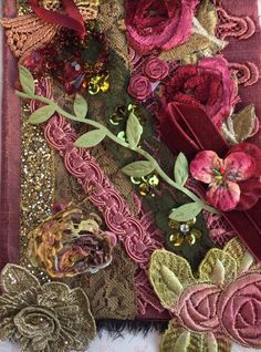 a close up of a piece of cloth with flowers on it and sequins