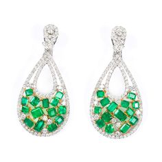 Magnificent Colombian emerald and diamond drop earrings in an 18K white and yellow gold setting. Featuring 7.2 carats of green emeralds (28 loose stones) with 5.44 carats of brilliant-cut diamonds (200 stones). Prong set 18K white and yellow gold 7.2 ct green emeralds 5.44 ct brilliant-cut diamonds MarkingHalmarks AKMS - 18K Measurements/WeightLength: 2 1/4 in. (5.7 cm)Width: 1 1/8 in. (3 cm)T.W.: 15 DWT (23.3 grams)WearExcellent condition. Luxury Green Diamond Earrings, Luxury Green Emerald Diamond Earrings, Green Diamond Earrings With 17 Jewels For Formal Events, Green Diamond Earrings With 17 Jewels For Formal Occasions, Green Diamond Drop Earrings With Accents, Luxury Green Diamond Earrings With Accents, Fine Jewelry Green Diamond Earrings, Green Diamond Earrings In Fine Jewelry Style, Green Diamond Earrings Fine Jewelry