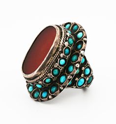 Central Asian Bukharan Uzbek and Turkmen Silver Ring with Turquoise and Carnelian Stones The Türkmen (Türkmen: Türkmen, Түркмен, توركمن) are an Oğuz Turkic speaking ethnic group that inhabit Türkmenistan (Turkmenistan) but also have sizeable populations in Afğanistan (Afghanistan), Türkiye (Turkey), and other Central-Asian countries. They are famous for their masterfully made jewelry. Their jewelry is typically made of high-quality silver and carnelian stones. Openwork designs, granulation, and gilding are common traits of their work. Whereas the Özbek (Özbek: Oʻzbek; Ўзбек, اوزبک) are a Qarluq Turkic speaking ethnic group, who primarily reside in Özbekistan (Uzbekistan). They also have sizeable populations in other Central Asian countries such as Afğanistan and Qırğızstan (Kyrgyzstan), am Traditional Silver Turquoise Ring, Traditional Oval Turquoise Ring, Traditional Turquoise Inlay Ring, Traditional Turquoise Gemstone Ring, Afghanistan Jewelry, Ethno Style, Asian Countries, Carnelian Stone, Made Jewelry