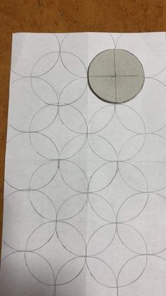 a piece of paper with circles drawn on it and a hole in the middle that has been cut out