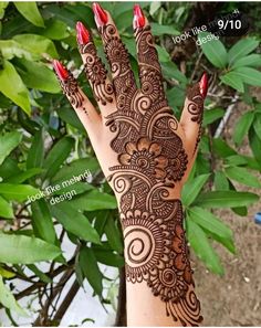 a woman's hand with henna tattoos on it